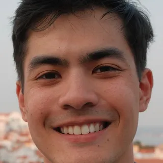 Brandon G., a PWP coaching client, smiling on a rooftop above a city.